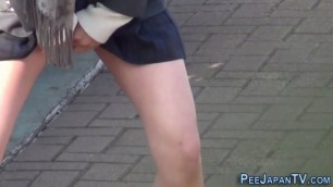 Japanese teen students peeing outside