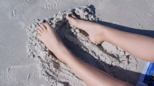 Sandy teen feet at the beach