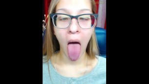 Cute girl with glasses opens mouth and crosses eyes!